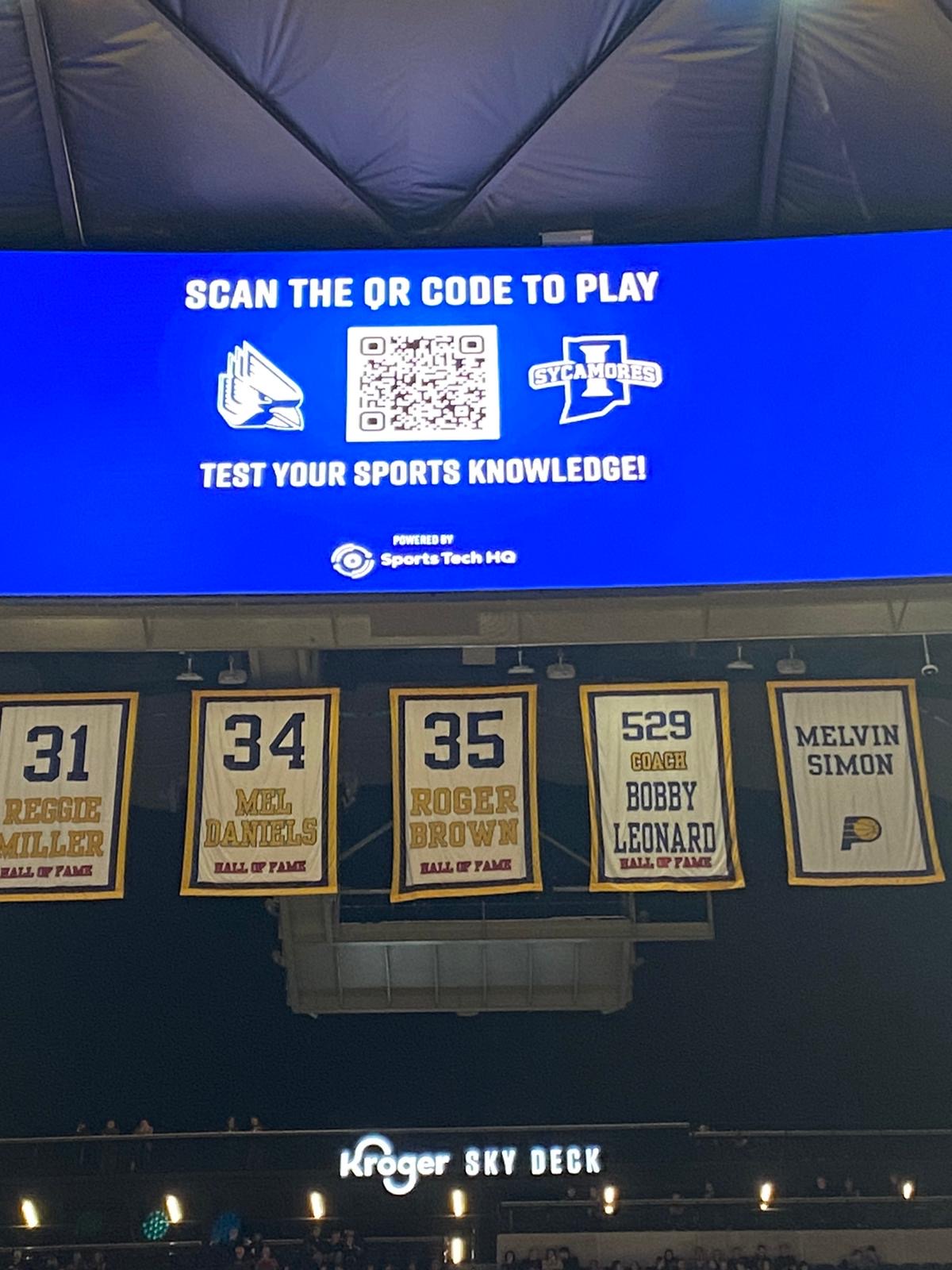 Indy Classic fan engagement at Gainbridge Fieldhouse, with a Sports Tech HQ QR-code quiz invitation above the Pacers banners.
