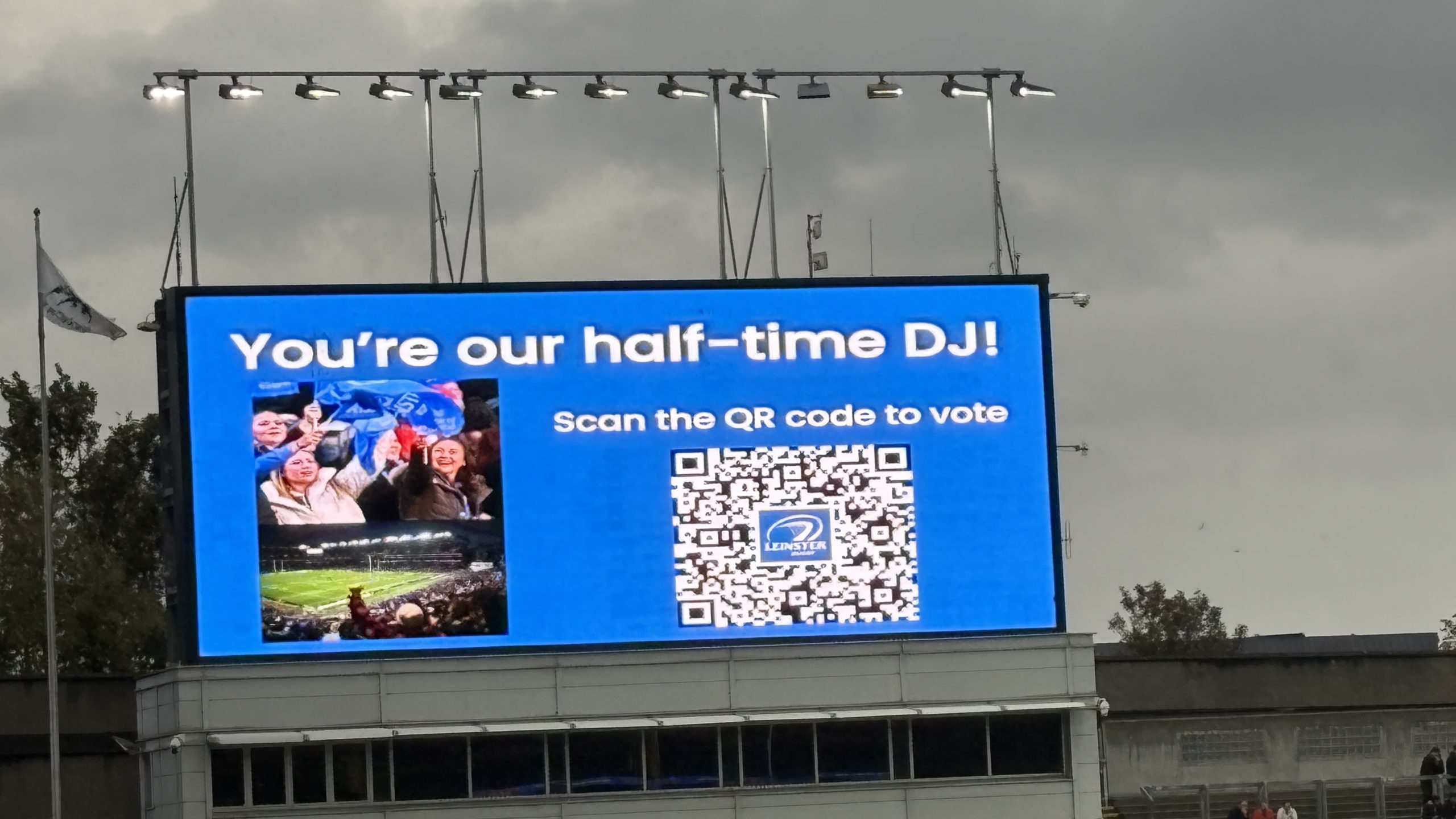 Leinster Rugby fan engagement at Croke Park, with the stadium screen asking supporters to scan a QR code and vote for the half-time song.